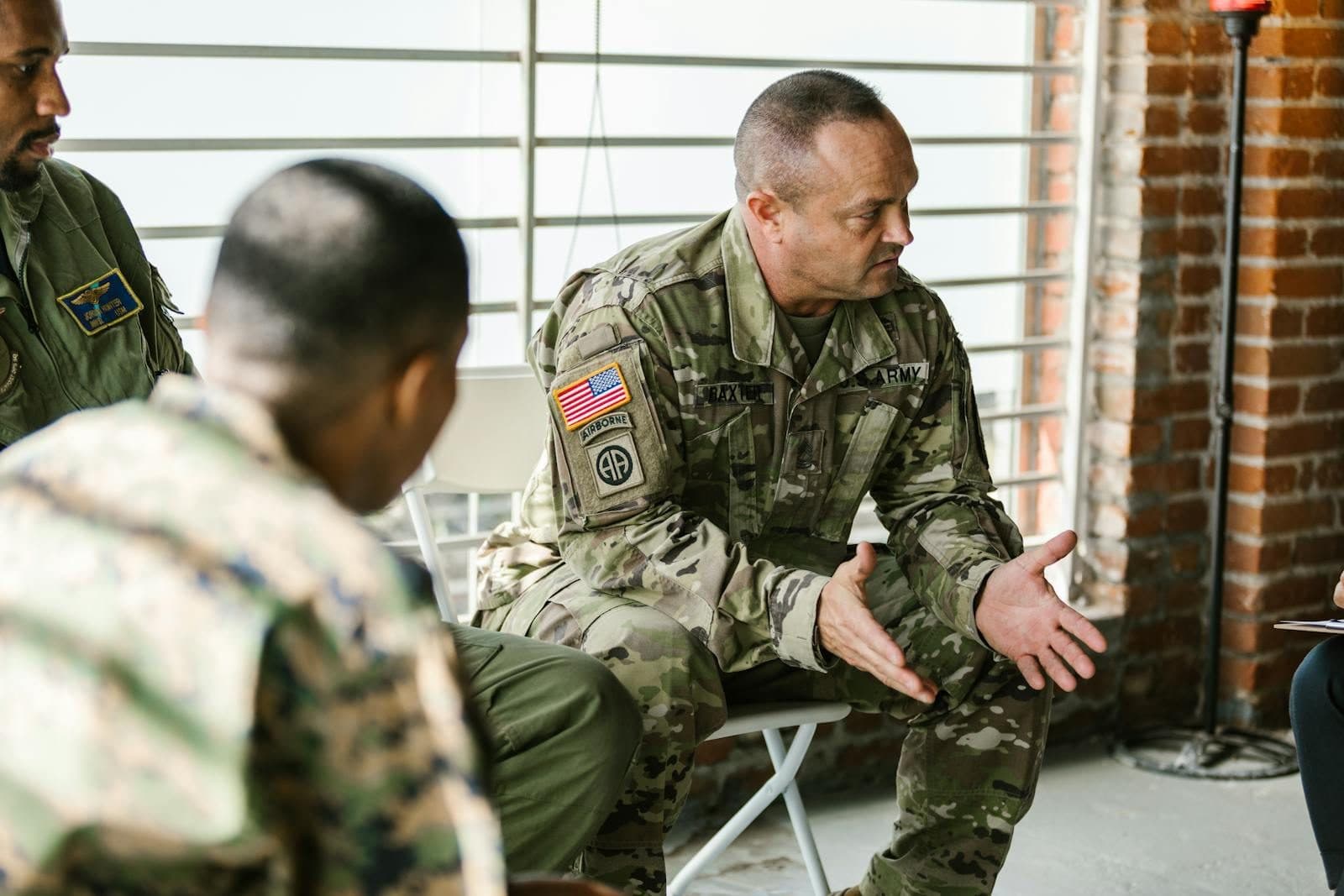 Service members in uniform talking together